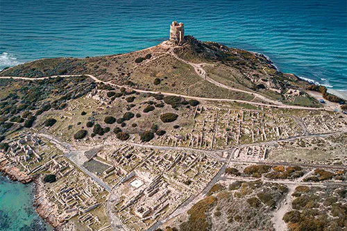 An aerial view of Tharros and the Mediterranean Sea on the western coast of Sardinia.