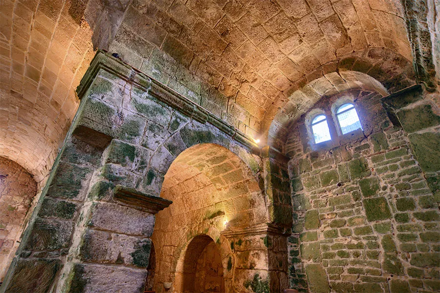 The interior of the church of San Giovanni. Sandstone blocks from older structures were used to build the church.