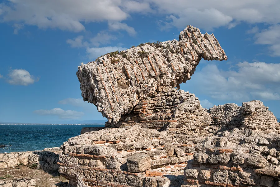 A triangular fragment of the cold room (frigidarium) in a bath complex in Tharros.