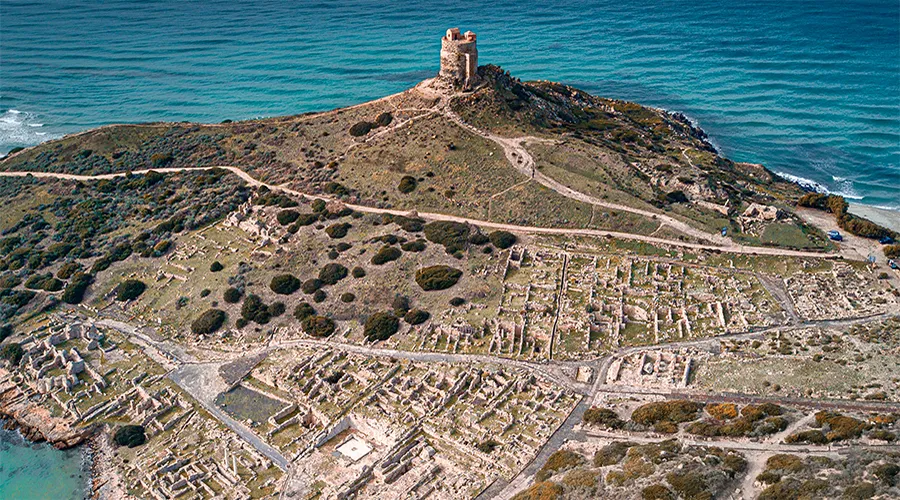 An aerial view of Tharros and the Mediterranean Sea on the western coast of Sardinia.